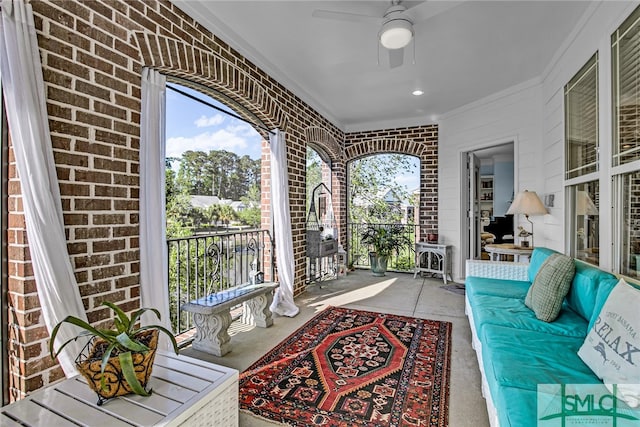 sunroom featuring ceiling fan and a healthy amount of sunlight