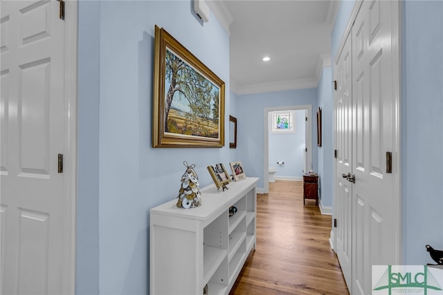 hall featuring crown molding and light wood-type flooring