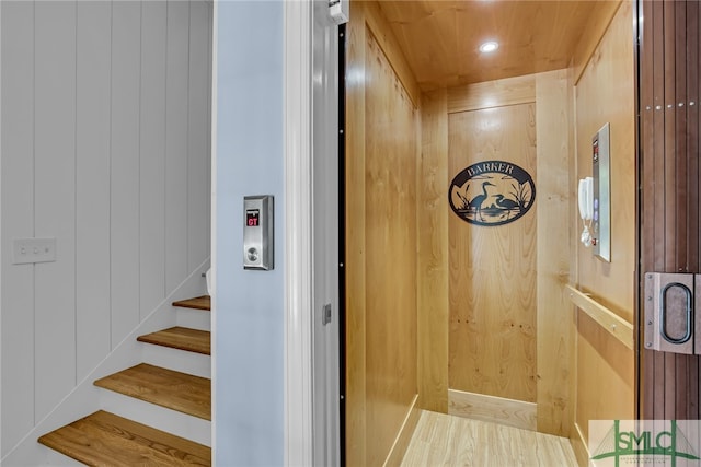 interior space featuring wood walls and elevator