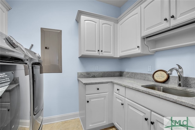 kitchen with white cabinetry, sink, light tile floors, and light stone countertops