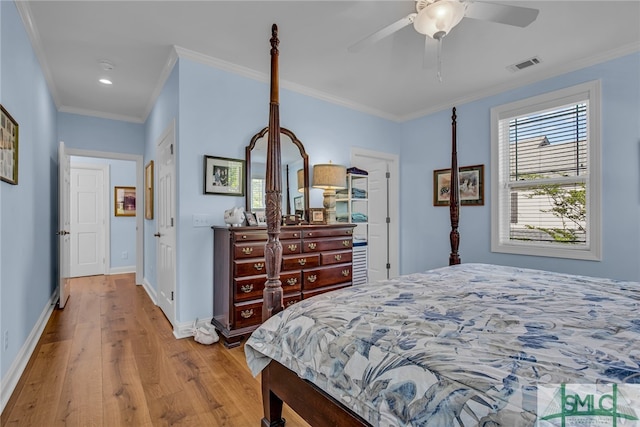 bedroom featuring ornamental molding, ceiling fan, and light hardwood / wood-style flooring