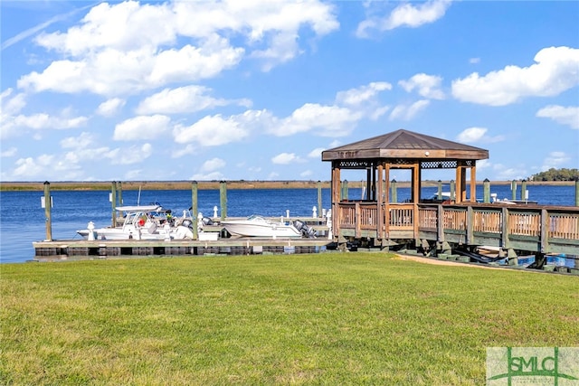 dock area with a water view, a gazebo, and a yard