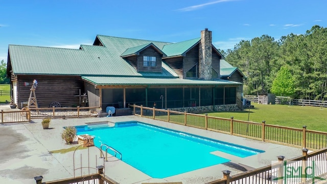 view of swimming pool with a diving board, a yard, and a patio