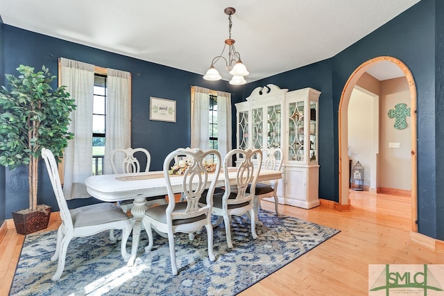 dining space with a chandelier and light wood-type flooring