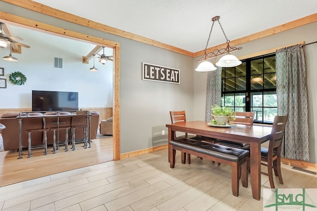 dining space with ceiling fan and light wood-type flooring