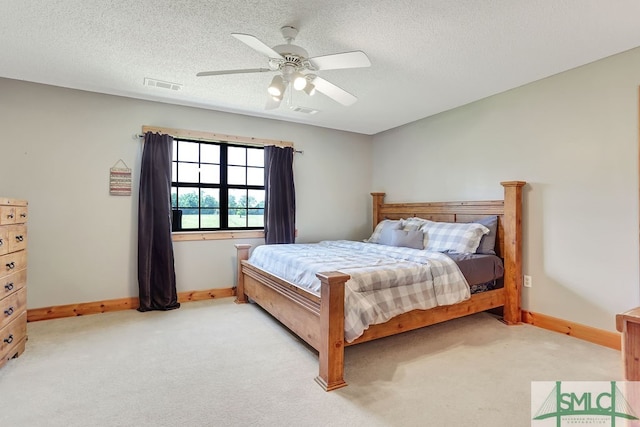 carpeted bedroom with a textured ceiling and ceiling fan