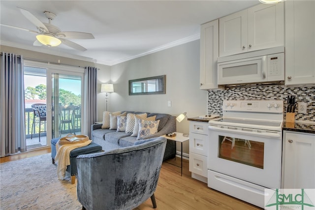 kitchen featuring light hardwood / wood-style flooring, white appliances, tasteful backsplash, and white cabinets