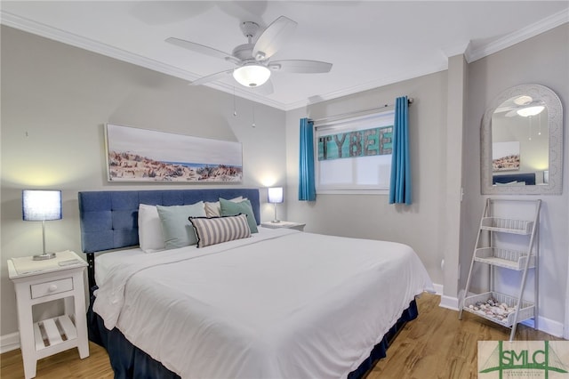 bedroom featuring ceiling fan, ornamental molding, and light hardwood / wood-style floors