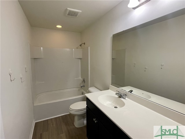 full bathroom featuring hardwood / wood-style floors, vanity, shower / bathtub combination, and toilet