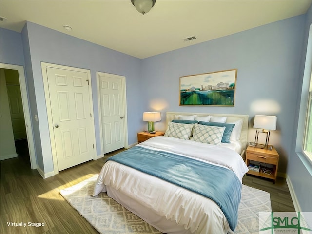 bedroom with dark hardwood / wood-style floors