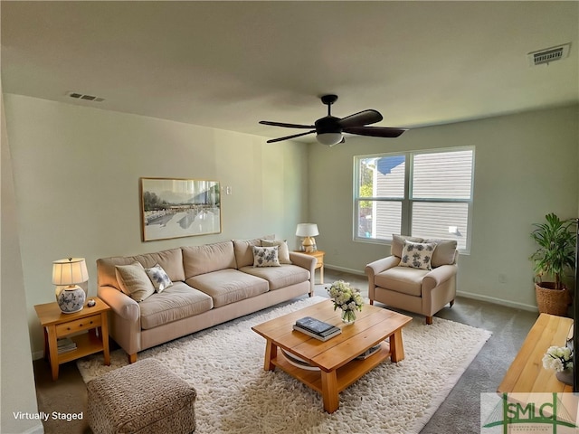 carpeted living room with ceiling fan