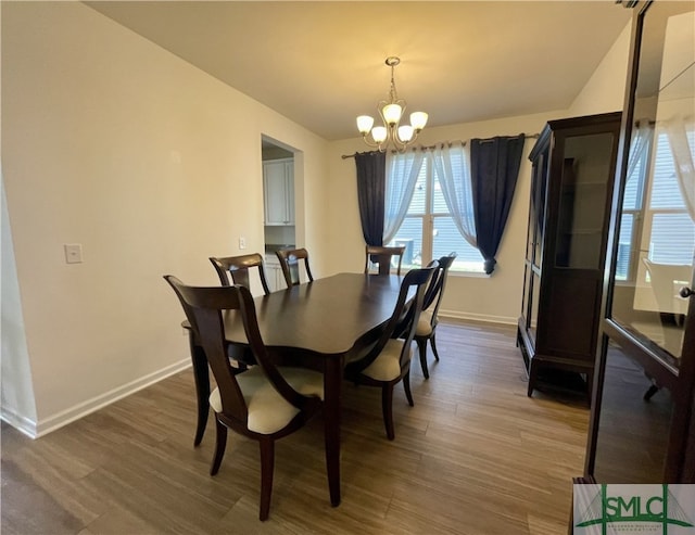 dining room featuring dark hardwood / wood-style floors and a notable chandelier