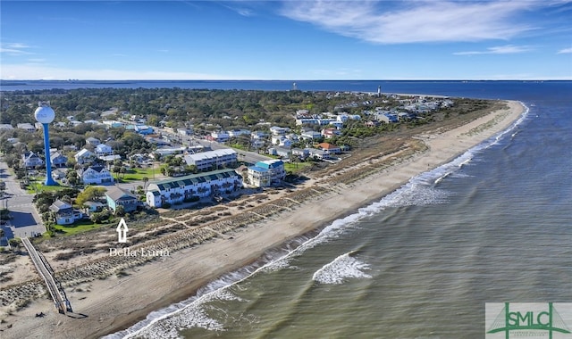 drone / aerial view featuring a water view and a view of the beach