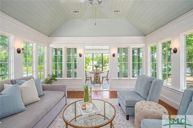 sunroom / solarium with vaulted ceiling, plenty of natural light, and wooden ceiling