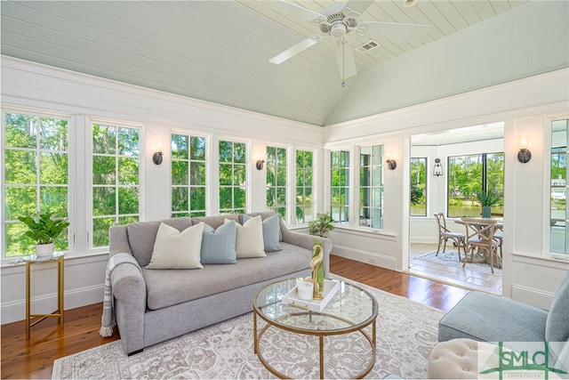 sunroom with a healthy amount of sunlight, lofted ceiling, and ceiling fan