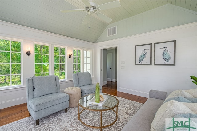 living room with a healthy amount of sunlight, ceiling fan, dark wood-type flooring, and lofted ceiling