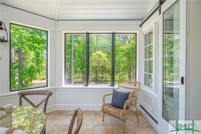 sunroom / solarium featuring a healthy amount of sunlight