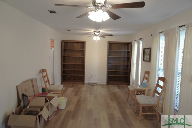 living area featuring ceiling fan and light wood-type flooring