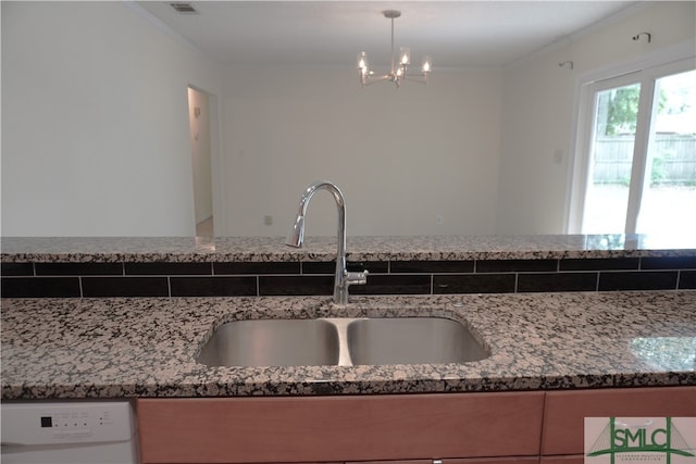 interior space featuring dishwasher, a chandelier, vanity, and crown molding