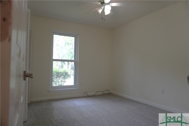 carpeted spare room with a wealth of natural light and ceiling fan