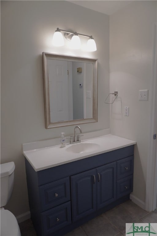 bathroom with vanity, tile floors, and toilet