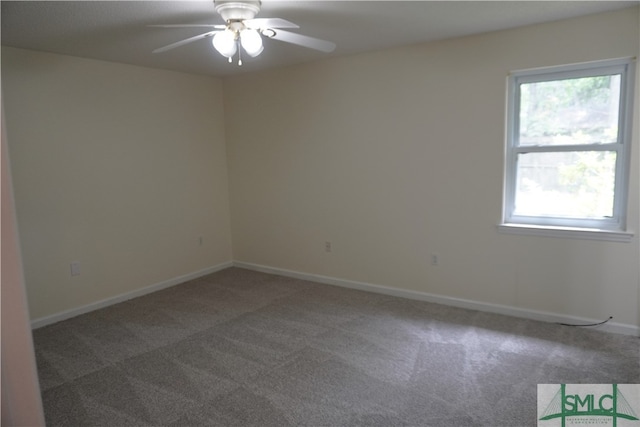 unfurnished room with ceiling fan and dark carpet