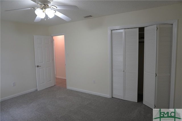 unfurnished bedroom featuring a closet, ceiling fan, and dark colored carpet