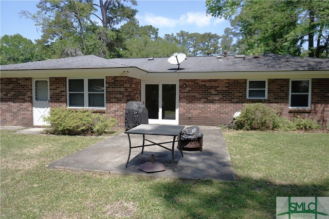 rear view of property with a patio area and a lawn