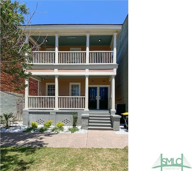 view of front facade featuring covered porch and a balcony