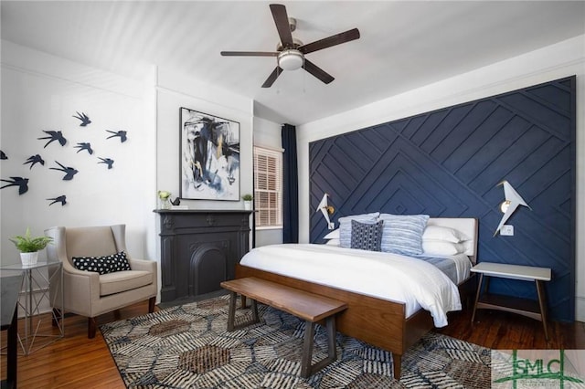 bedroom with hardwood / wood-style flooring and ceiling fan