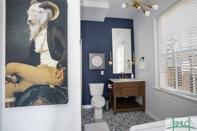 bathroom featuring a wealth of natural light, vanity, toilet, and tile floors