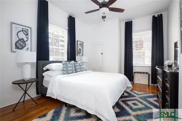 bedroom featuring ceiling fan and dark wood-type flooring