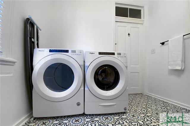 laundry area featuring washer and clothes dryer and tile floors