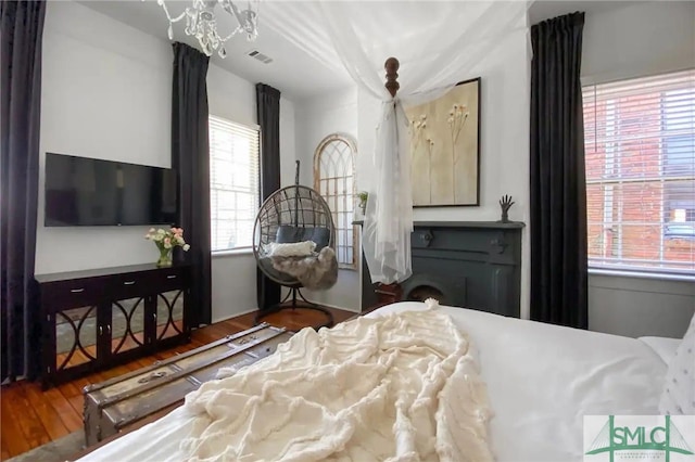 bedroom featuring a notable chandelier and wood-type flooring