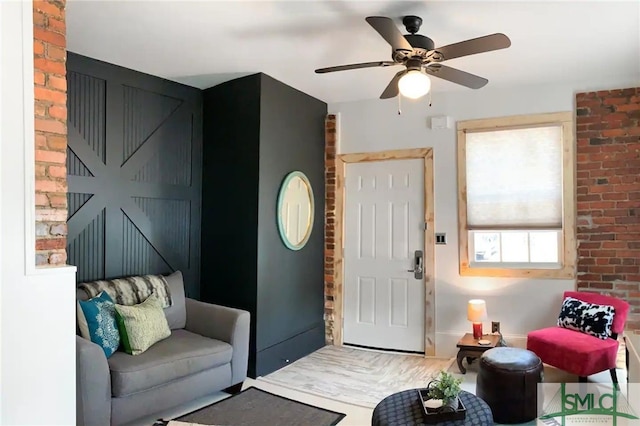 living room with brick wall, ceiling fan, and hardwood / wood-style floors