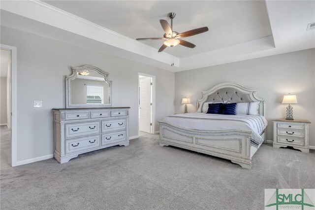 bedroom featuring a tray ceiling, ceiling fan, and light colored carpet