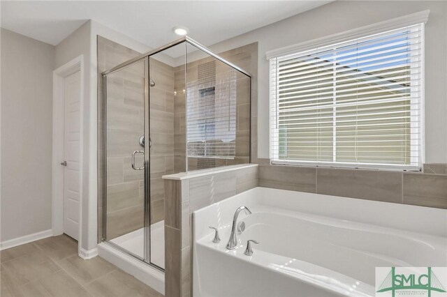 bathroom featuring separate shower and tub