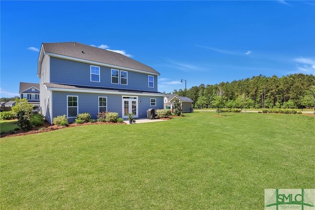 back of house with a patio area and a yard