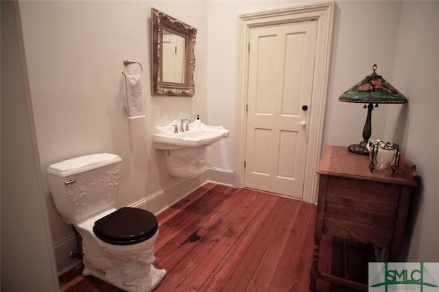 bathroom featuring hardwood / wood-style floors, sink, and toilet