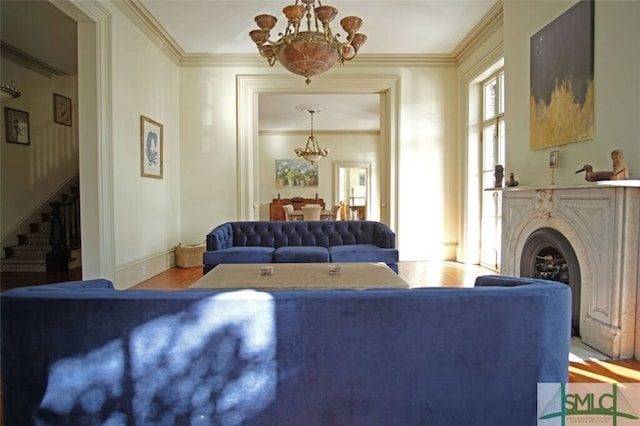 living room featuring ornamental molding, an inviting chandelier, and hardwood / wood-style floors