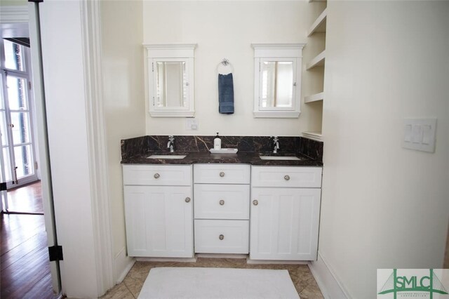 bathroom with tile floors and double sink vanity