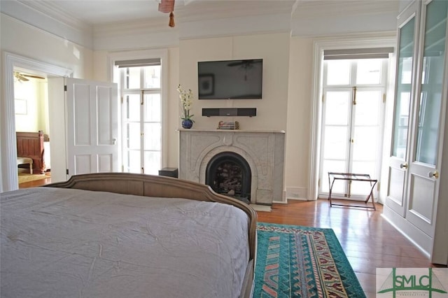 bedroom with crown molding and hardwood / wood-style flooring