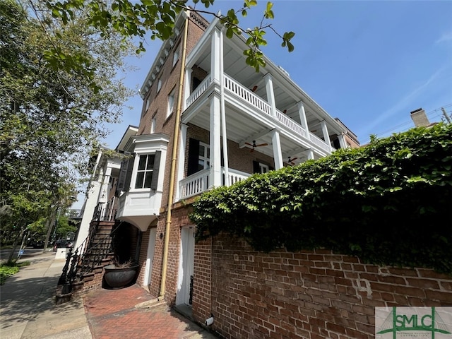 view of side of home featuring ceiling fan