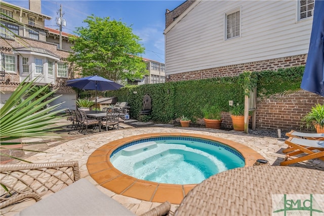 view of swimming pool with a patio area and an in ground hot tub