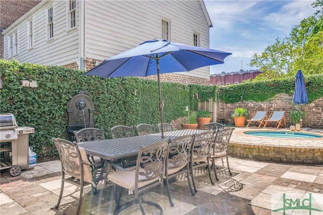 view of patio / terrace featuring a hot tub and area for grilling