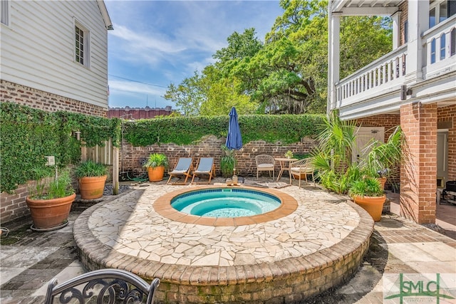 view of swimming pool featuring a patio and an in ground hot tub