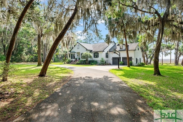 view of front of house with a front lawn and a garage