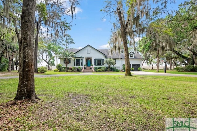 view of front of property with a garage and a front yard