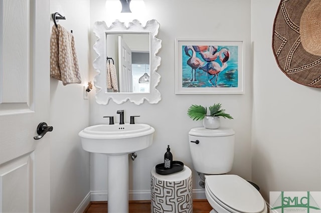 bathroom featuring hardwood / wood-style floors and toilet