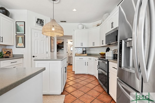 kitchen with appliances with stainless steel finishes, a kitchen island, backsplash, pendant lighting, and light tile floors